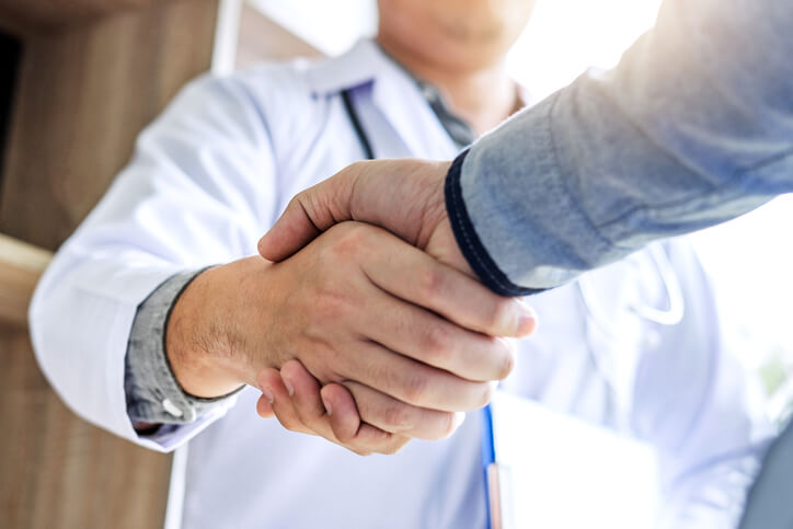 Doctor warm welcoming his patient